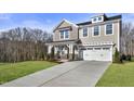 Two-story home with a neutral color scheme, two-car garage, and landscaping at 23 Eagle Crest Ct # Holly English Country, Lillington, NC 27546