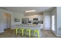 Modern kitchen with white cabinets, stainless steel appliances, and an island with seating at 1915 Frost Dr, Haw River, NC 27258
