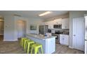 Modern kitchen with white cabinets, stainless steel appliances and island at 1911 Frost Dr, Haw River, NC 27258