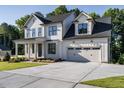 Two story farmhouse style home with a large driveway at 6045 Scalybark Road, Durham, NC 27712