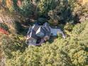 House with driveway, basketball court, and surrounding trees at 12817 Strickland Rd, Raleigh, NC 27613