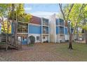 Front view of a two-story building with blue siding, balconies, and landscaping at 7040 Longstreet Dr # C, Raleigh, NC 27615