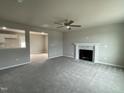 Spacious living room with neutral carpeting and a fireplace at 726 Sherrill Farm Dr, Benson, NC 27504