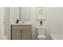 Clean bathroom with vanity, toilet, and bathtub at 135 St Andrews Dr, Zebulon, NC 27597