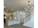 Modern kitchen with white cabinets, quartz countertops, and stainless steel appliances at 137 Swain St, Clayton, NC 27527