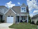 Two-story house with brick and gray siding, and two-car garage at 137 Swain St, Clayton, NC 27527