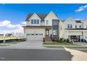 Two-story modern farmhouse with gray and white exterior, two car garage at 465 Douglas Falls Dr, Wendell, NC 27591