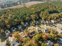 Aerial view of houses in a residential neighborhood with fall foliage at 1608 Irving Place, Creedmoor, NC 27522