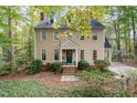 Two-story house with beige siding, green door, and landscaping at 145 Brannigan Pl, Cary, NC 27511