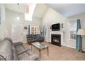 Living room with fireplace and vaulted ceiling at 1412 Hanford Hills Rd, Graham, NC 27253