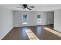 Living room with hardwood floors and large windows offering abundant natural light at 3181 Hardie St, Creedmoor, NC 27522