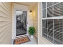 Townhome entrance with glass front door, window, and welcome mat at 2633 Vega Ct, Raleigh, NC 27614