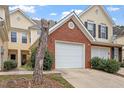 Brick front of townhome with attached garage and landscaping at 2633 Vega Ct, Raleigh, NC 27614