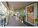 Side view of a front porch with rocking chairs and autumnal decorations at 7925 S Highway 55, Willow Springs, NC 27592