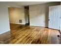 Bright and airy living room featuring hardwood floors and access to other rooms at 733 Carlisle St, Raleigh, NC 27610