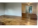 Hardwood floors throughout the spacious living room, with a view into the adjacent dining area at 733 Carlisle St, Raleigh, NC 27610