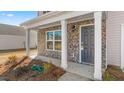Inviting house exterior with stone accents and a covered porch at 317 Leven Dr, Gibsonville, NC 27249