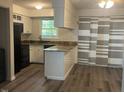 Kitchen with granite countertops, black appliances, and an island at 1111 Nottingham Cir, Cary, NC 27511