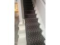 Staircase with patterned runner and gray carpeting at 1111 Nottingham Cir, Cary, NC 27511