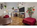 Living room with hardwood floors, fireplace, and large TV at 2125 Star Sapphire Dr, Raleigh, NC 27610