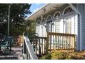 Wooden deck with rocking chairs and access to the house at 316 E South St, Raleigh, NC 27601