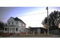 Light blue two-story house with a front porch and brick wall at 316 E South St, Raleigh, NC 27601