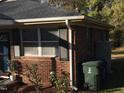 Brick house side view with landscaping and trash bins at 308 E East End Ave, Durham, NC 27703