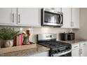 Stainless steel appliances and granite countertops highlight this kitchen at 6429 Alfalfa Ln, Wake Forest, NC 27587