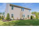 Gray house exterior showcasing a backyard and landscaping at 316 Leven Dr, Gibsonville, NC 27249