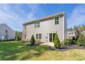 Gray house with a backyard, landscaping, and trees at 316 Leven Dr, Gibsonville, NC 27249
