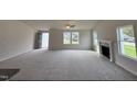 Large living room with grey carpet, fireplace, and high ceiling at 378 Magnolia Run Way, Benson, NC 27504