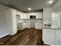 Modern kitchen with white cabinets and granite countertops at 79 Tulipfield Way, Benson, NC 27504