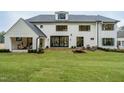 Back of house with patio, water feature, and lawn at 013 Bartley Holleman Rd # 13, New Hill, NC 27562