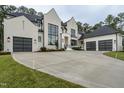 Modern house with white brick, black accents, and three car garage at 013 Bartley Holleman Rd # 13, New Hill, NC 27562