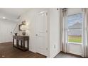 Bright foyer with hardwood floors, a console table, and a coat closet at 1915 Puffin Dr # 198, Haw River, NC 27258