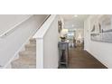 Modern staircase with carpeted steps and white railings leading to the upper level at 1915 Puffin Dr # 198, Haw River, NC 27258