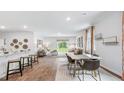 Open concept dining area with hardwood floors and modern light fixtures at 1915 Puffin Dr # 198, Haw River, NC 27258