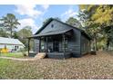 Dark gray house with a covered porch and landscaping at 617 Orange Heights Loop Rd, Hillsborough, NC 27278