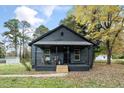 Dark gray house with a covered porch and landscaping at 617 Orange Heights Loop Rd, Hillsborough, NC 27278