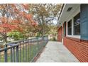 Brick porch with metal railing overlooking wooded area at 603 Nellane Dr, Garner, NC 27529
