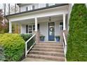 Welcoming front entrance with brick steps and a blue front door at 30 Willow Bend Dr, Youngsville, NC 27596