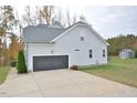 Two-car garage with a spacious driveway and shed in the backyard at 30 Willow Bend Dr, Youngsville, NC 27596