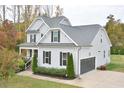 Gray house with a two-car garage and landscaping at 30 Willow Bend Dr, Youngsville, NC 27596