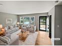 Spacious living room with hardwood floors, large windows, and a view of the front yard at 1526 Clermont Rd, Durham, NC 27713