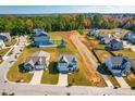 Aerial view of a neighborhood with houses and a park-like setting at 52 E Piston Pt, Clayton, NC 27520