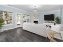 Living room with fireplace and access to deck, hardwood floors at 2106 White Pond Ct, Apex, NC 27523