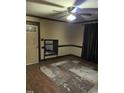 Living room with wood floors, ceiling fan, and area rug at 206 W Garner Rd, Garner, NC 27529