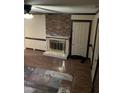 Living room with brick fireplace, wood floors, and ceiling fan at 206 W Garner Rd, Garner, NC 27529