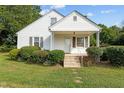 White house with a covered porch, steps, and landscaping at 9847 Snow Camp Rd, Snow Camp, NC 27349