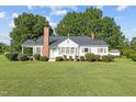 Charming white house with a covered porch and well-manicured lawn at 9847 Snow Camp Rd, Snow Camp, NC 27349